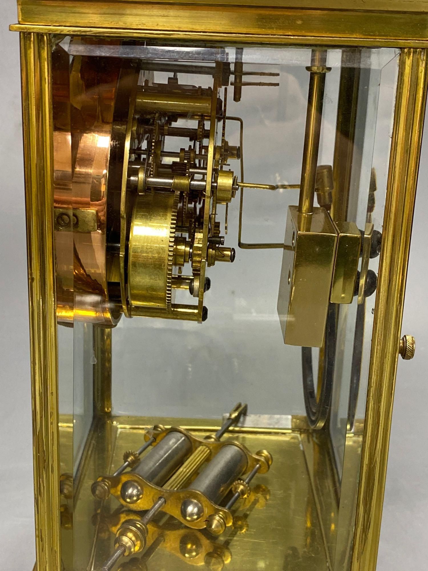 A lacquered brass four-glass mantel clock, Waterbury Clock Co., USA, gong striking movement, height 24cm